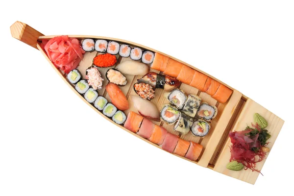Dřevěná loď s rohlíky a sushi — Stock fotografie