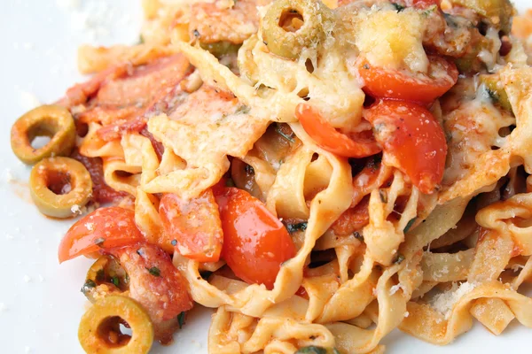 Fettuccine s rajčaty, olivami a slaninou zblízka — Stock fotografie