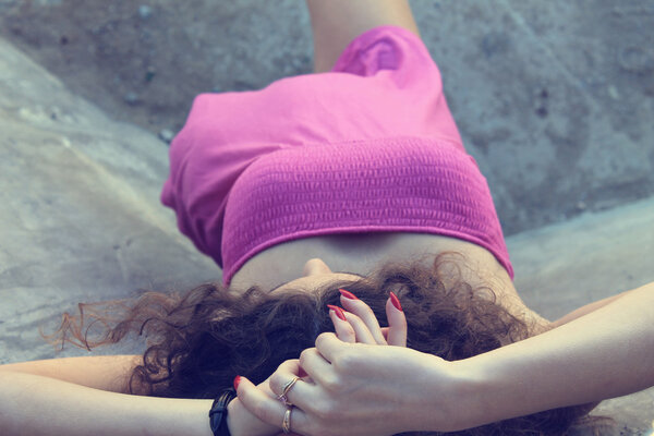 Fashionable curly brunette model posing