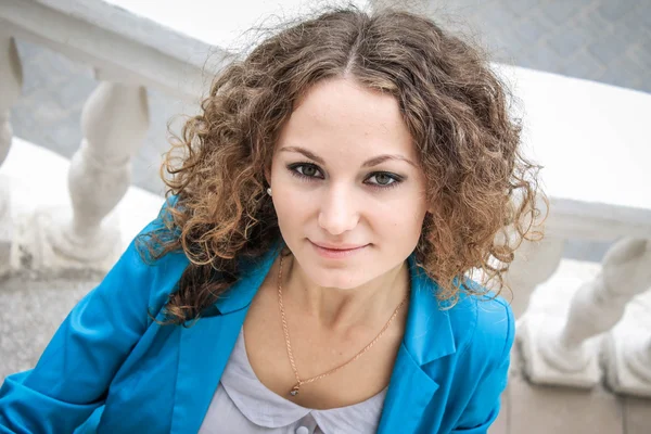 Portrait of beautiful curly girl in old city — Stock Photo, Image