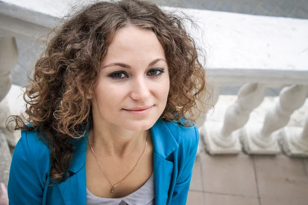 Portrait of beautiful curly girl in old city — Stock Photo, Image