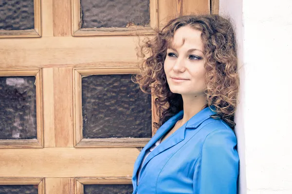 Portrait of beautiful curly girl in old city — Stock Photo, Image