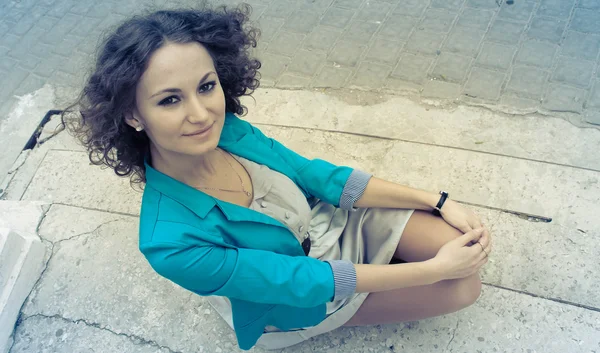 Beautiful curly girl in old city — Stock Photo, Image