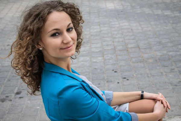 Beautiful curly girl in old city — Stock Photo, Image