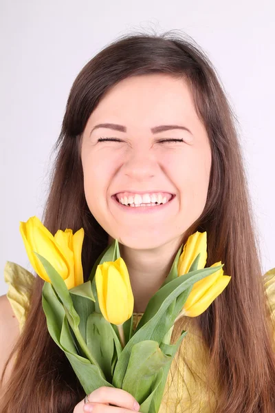 Girl with yellow tulips — Stock Photo, Image