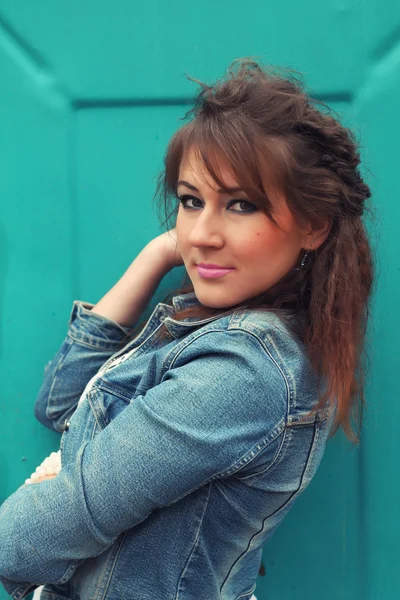 Girl near turquoise garage in denim — Stock Photo, Image