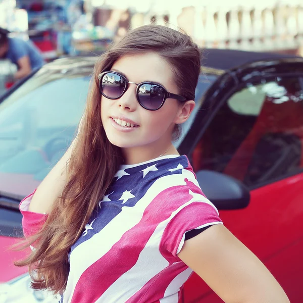 Pretty American girl in American flag t-shirt. — Stock Photo, Image