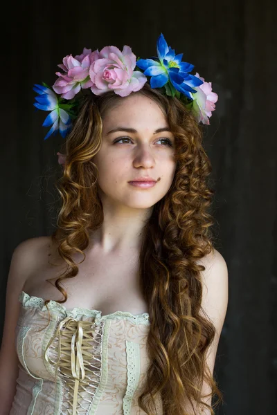 Beautiful redhead girl with flowers isolated — Stock Photo, Image
