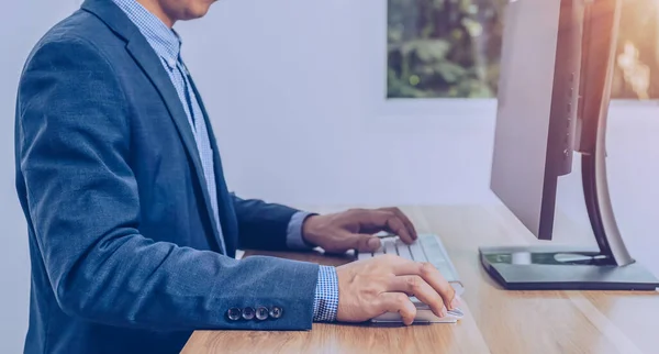 business people sitting in front of the computer screen