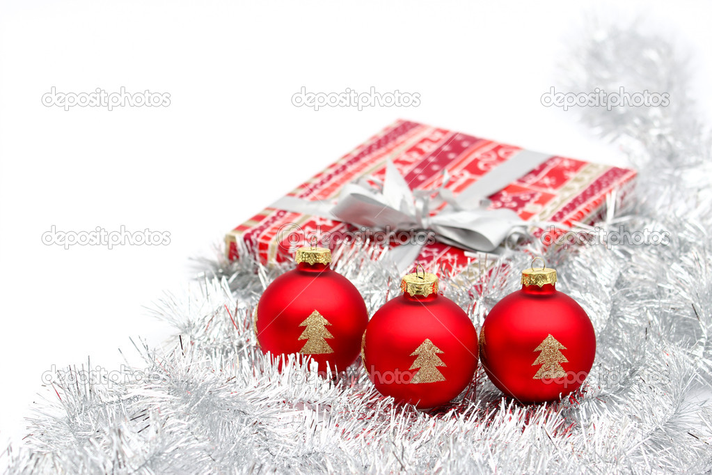 Three red christmas ball and present on white background