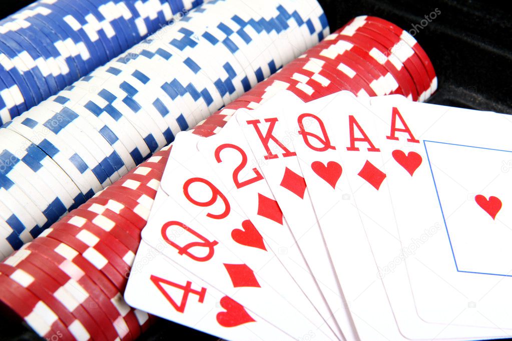 Red poker cards and different colour of chips