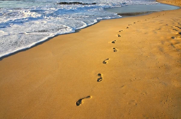 Pisadas en la playa y el agua — Foto de Stock