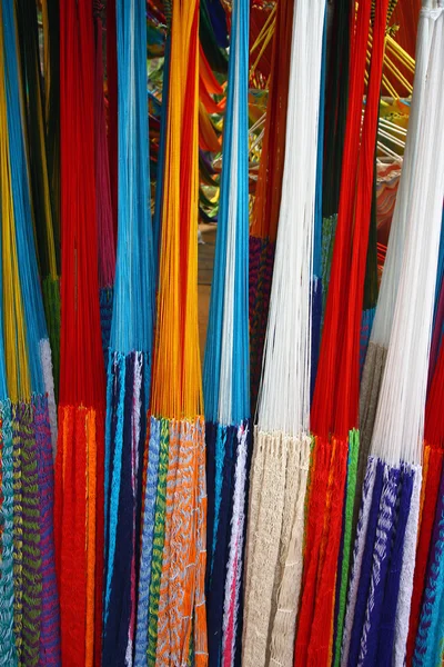 Many colored hammocks hang together in the shop — Stock Photo, Image