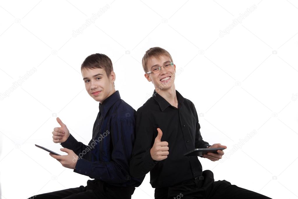 couple of happy teenagers with tablet computer