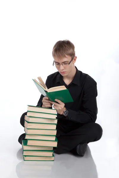 Chico adolescente con libros en el suelo —  Fotos de Stock