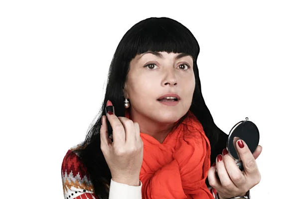 Beautiful brunette woman paints her lips — Stock Photo, Image