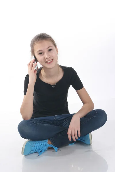 Girl talking on the phone sitting on the floor — Stock Photo, Image