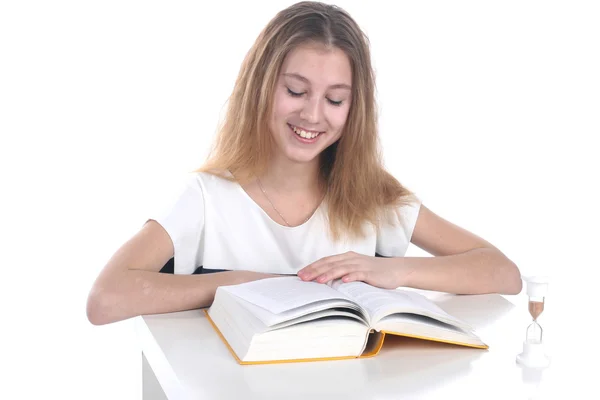 Schoolgirl reading on a white background — Stock Photo, Image