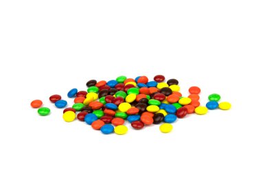 Colorful chocolate in and out of focus on white background.