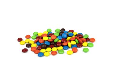 Colorful chocolate in and out of focus on white background.