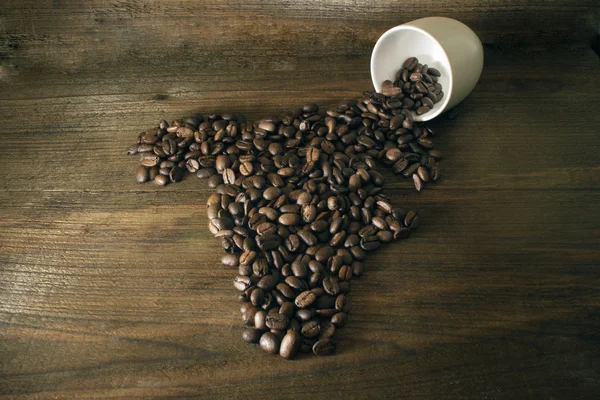 Kaffebönor som anges i form av Afrika mot bac — Stockfoto