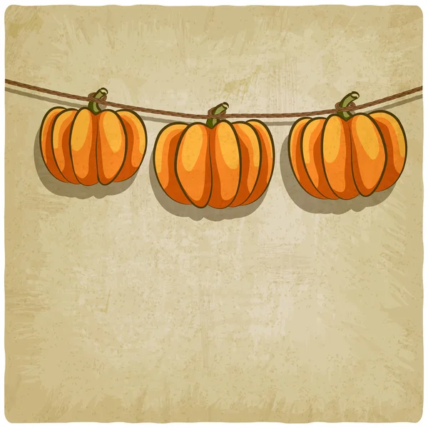 Old background with pumpkins on rope — Stock Vector