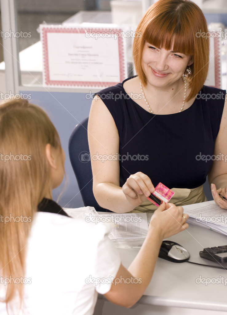 Girl gives a bank card customer