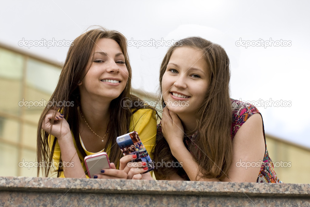 Smiling girls with phones