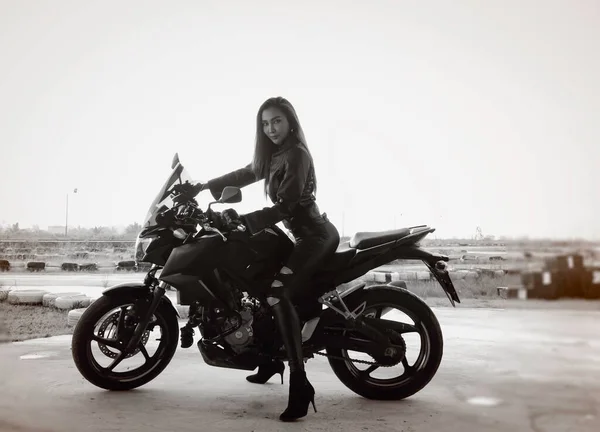 摩托车由身穿黑色西服 骑自行车的美女 模特儿 黑白色调 老式风格 周围光线模糊的美女驾驶 — 图库照片