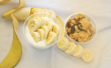 Dilimlenmiş muz ve bulanık ışıkla dolu seçici yoğurt köpüğünde