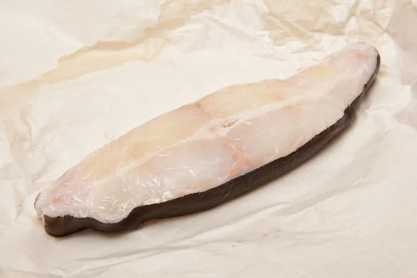 Halibut fish steak isolated on a white studio background. — Stock Photo, Image