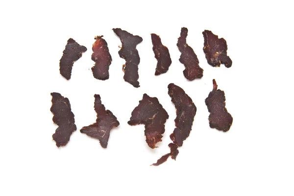 Gesneden biltong of beef jerky geïsoleerd op een witte achtergrond — Stockfoto