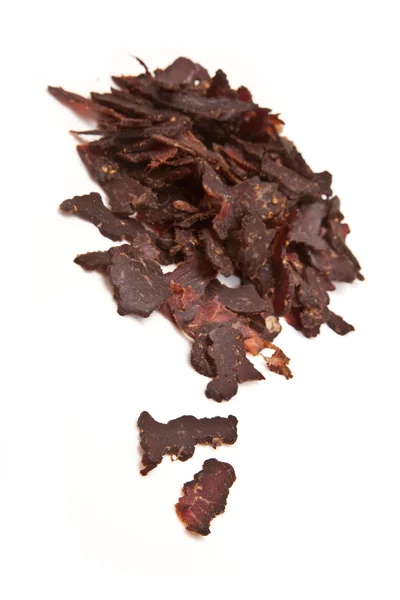 Gesneden biltong of beef jerky geïsoleerd op een witte achtergrond — Stockfoto