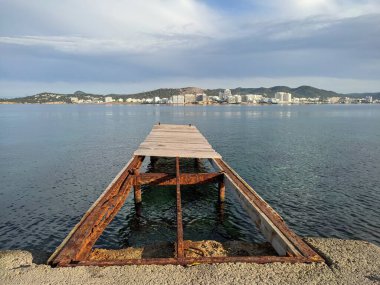 İbiza adasındaki bir körfezde eski ahşap iskelede. Yaz tatili kavramı.