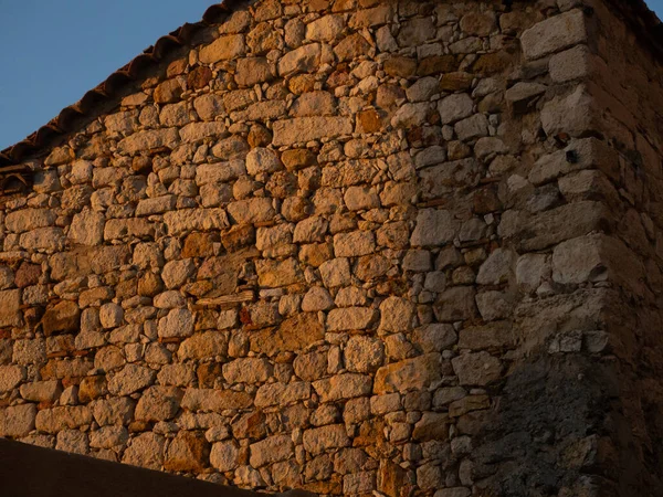 stone wall at sunset. Concept of sustainable architecture hd image