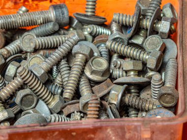 group of rusty screws in a box due to the passage of time. HD image