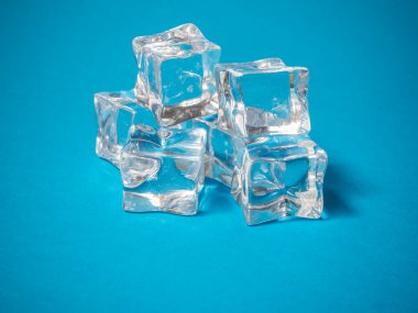 a batch of ice cubes on a blue background. Summer concept. HD image