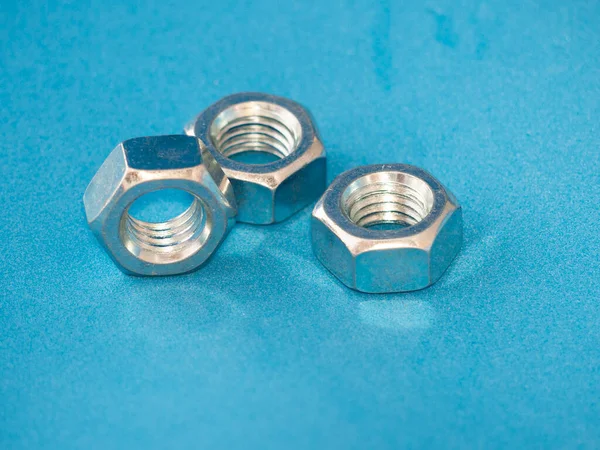 Chrome Plated Metal Nuts Blue Background Technology Concept Image —  Fotos de Stock