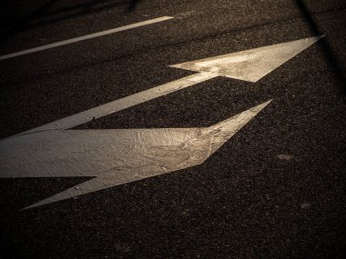 directional arrows on a road after a rainy day. hd image
