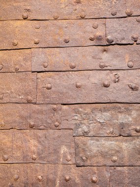 door covered with aged rusty wrought iron panels and studs High quality photo
