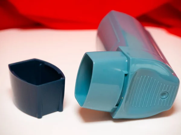 a blue-colored asthma inalator. Asthma disease concept hd image