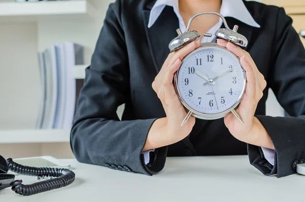 Young business women with clock — Stock Photo, Image