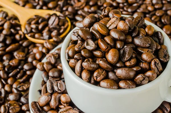 Coffee beans on cup — Stock Photo, Image