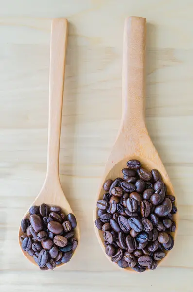 Coffee beans on spoon — Stock Photo, Image