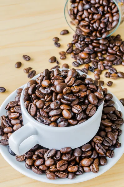 Coffee beans on cup — Stock Photo, Image