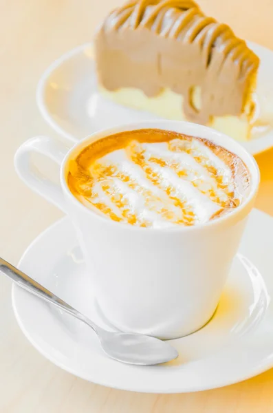 Coffee in white cup and caramel on top — Stock Photo, Image