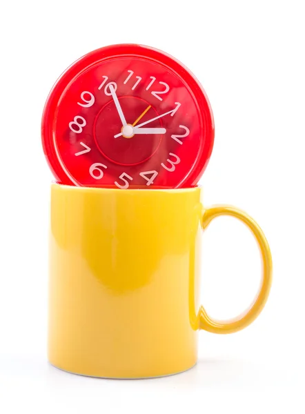 Желтая кружка и часы — стоковое фото