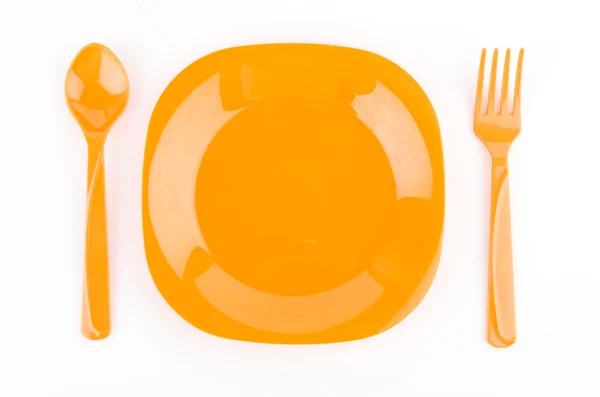 Цветная ложка, вилка и тарелка — стоковое фото