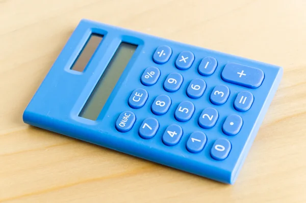 Calculator on wood table — Stock Photo, Image