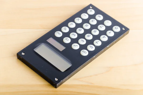 Calculator on wood table — Stock Photo, Image